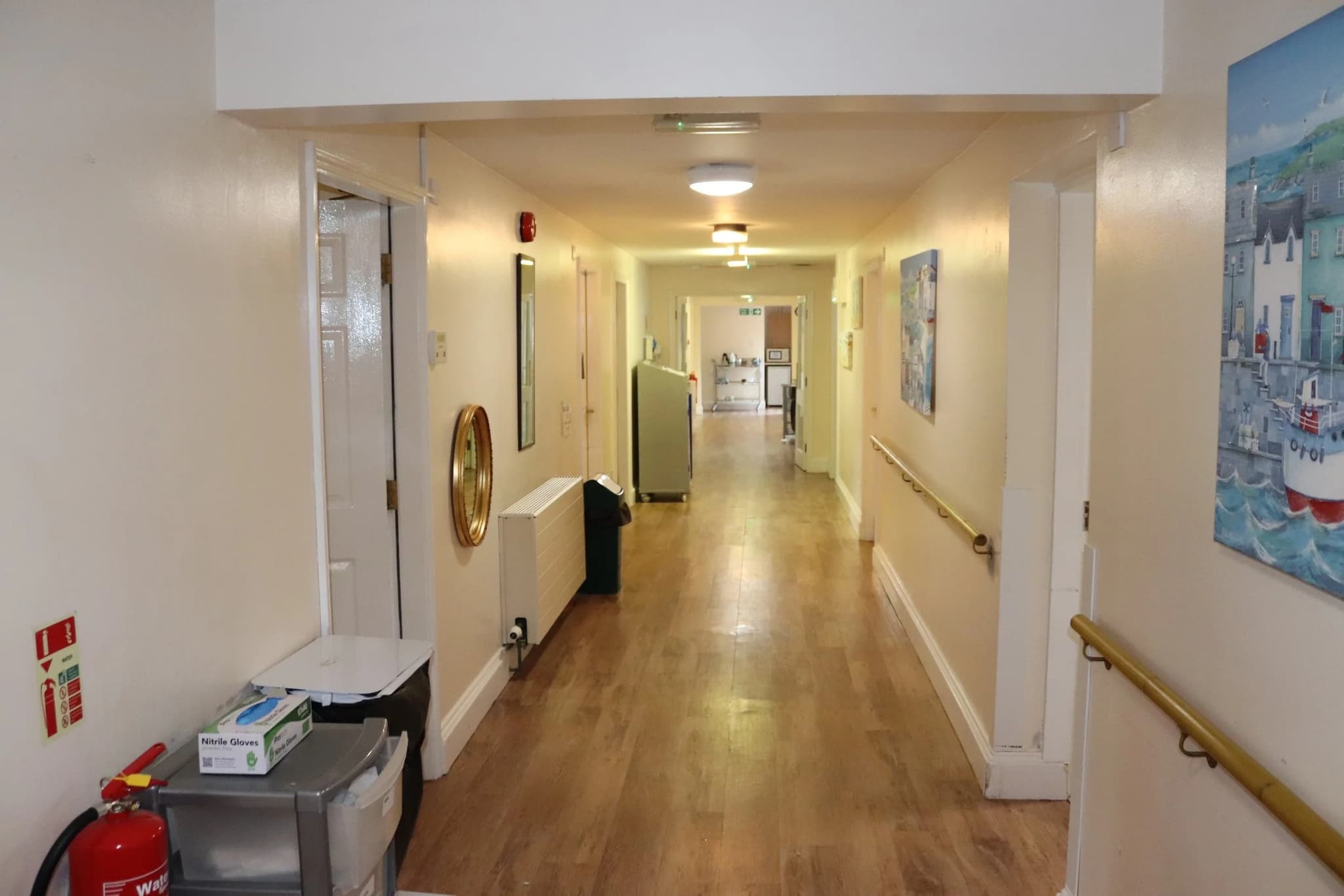 Wide accessible care corridor with safety handrails and lift access