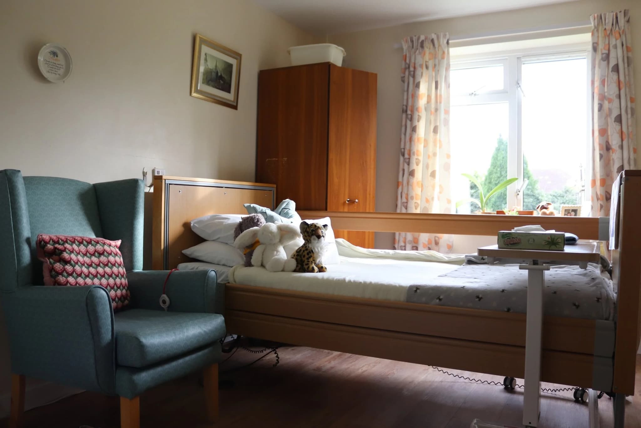 Comfortable private en-suite bedroom with armchair at Harrowby Lodge